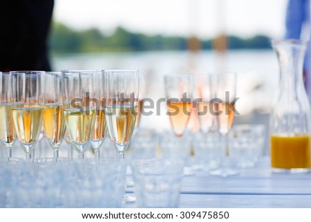 Glasses with champagne, orange juice and wine on summer wedding. Selective focus