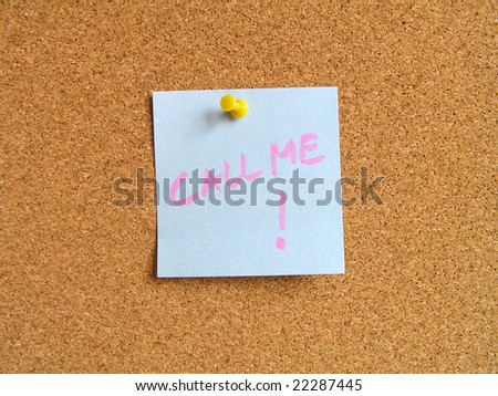 Blue small sticky note on an office cork bulletin board. Call me.
