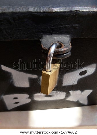A big lock on a tip box.