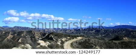 Road through mountains under blue sky, California