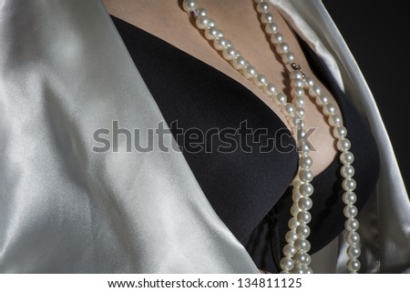 Black bra with pearls and dressing-gown