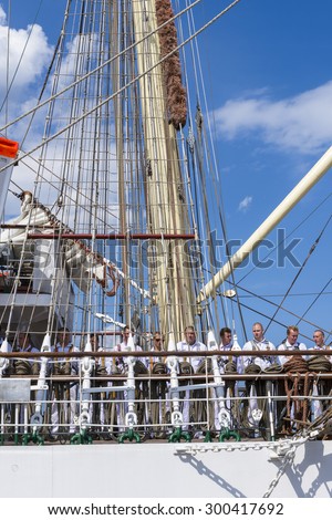 GDYNIA, POLAND - AUGUST 13, 2014:  Sailors on the Polish training ship Dar Mlodziezy in Gdynia port. The ship till 2014 has trained over 14 000 students of maritime Polish and foreign universities.