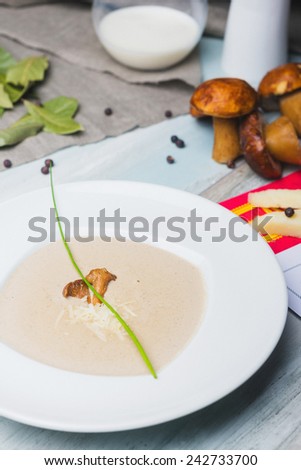 Mushroom creame soup with cheese and milk on the wooden table