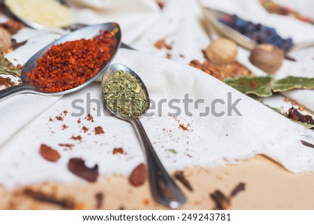 mix of different spices and herbs on a table with decor