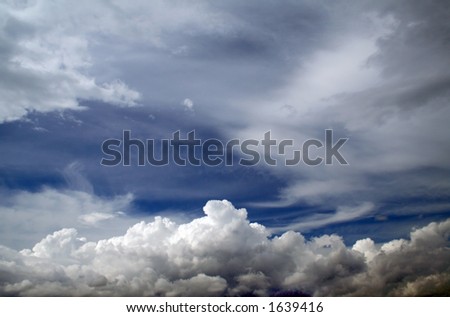 White cumulus and cirri of a cloud in the dark blue sky
