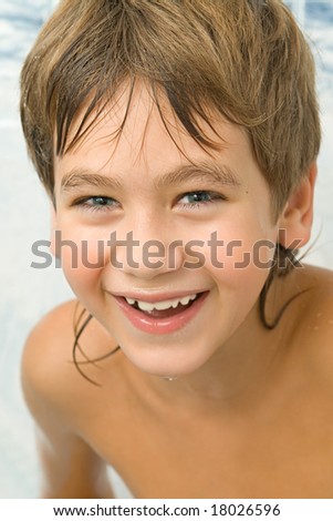 Got wet smiling boy in a bathroom