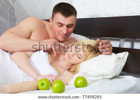Boyfriend looking at his girlfriend who is sleeping