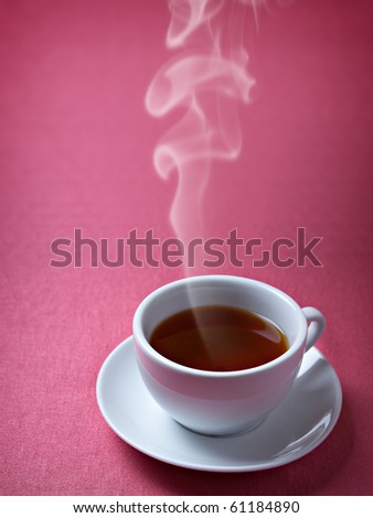 Cup of hot tea on the pink background