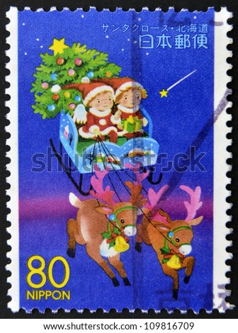 JAPAN - CIRCA 1999: A stamp printed in Japan,  shows children in a sleigh of Santa Claus, circa 1999