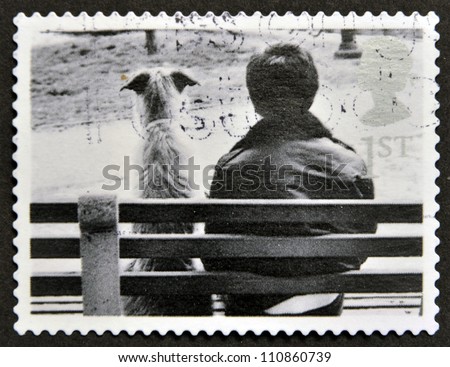 UNITED KINGDOM - CIRCA 2001: A stamp printed in Great Britain shows Dog and Owner on Bench, circa 2001