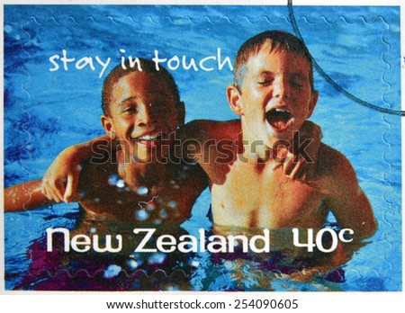 NEW ZEALAND- CIRCA 1998: A stamp printed in New Zealand shows friends at the pool, stay in touch, circa 1998