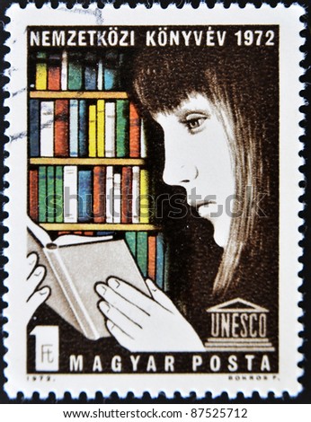 HUNGARY - CIRCA 1972: A stamp printed in Hungary shows a young woman reading a book in a library, circa 1972