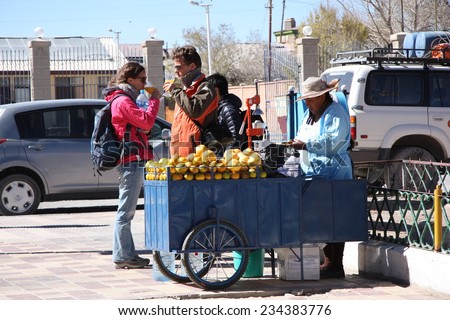 BOLIVIA, UYUNI, 17 SEPTEMBER 2014 - Street seller of orange juice in Uyuni, Bolivia, South America