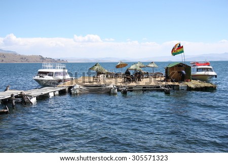 BOLIVIA, TITICACA LAKE, 13 SEPTEMBER 2013 - Tourist Boats at floating island on Titicaca lake in Bolivia, South America