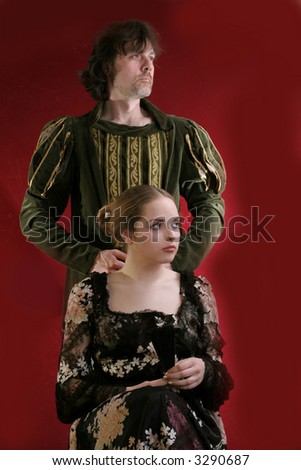 pretty young lady  in old time and  man in green in medieval dress  over red