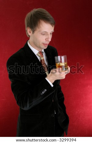 happy businessman with whisky glass - boss isolated on red