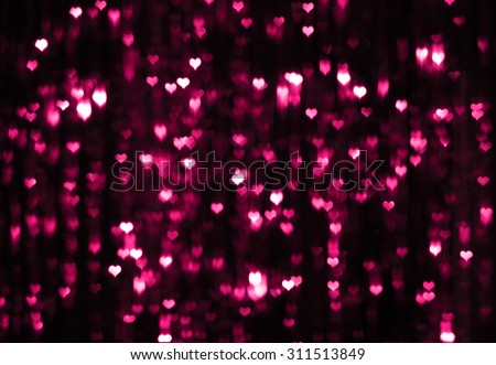 Abstract dark purple valentine background with heart-shaped boke effect