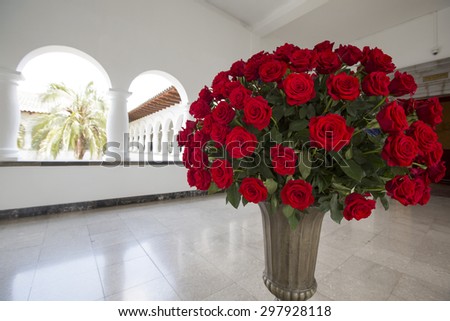 QUITO, ECUADOR, FEBRUARY 26: Huge bunch of red roses in stone vase located in the Presidential Palace, Quito. Ecuador 2015.