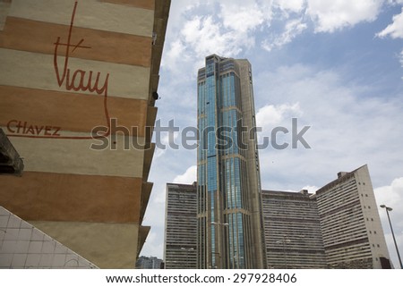 CARACAS, VENEZUELA, APRIL 20: Downtown of Caracas with view on hight residential buildings, the official signature of President Hugo Chavez is also visible on a wall in the foreground. Venezuela 2015