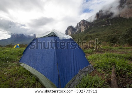 Low angle of blue wet tent early in the morning at the last campsite before climbing Mount Roraima, Gran Sabana. Venezuela 2015.