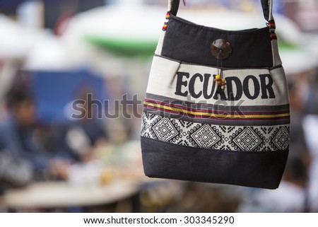 Handmade wool bag for sale at the outdoor craft market in Otavalo. Ecuador is written on the bag.