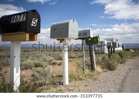 YUMA, AZ, SEPTEMBER 15, 2012: Row of mailboxes along Arizona highway with blue cloudy sky and mountains in the background. Arizona, USA 2012