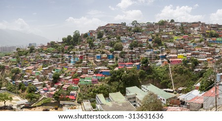Panorama of small wooden colored houses in the poor neighborhood in Caracas. It cover the hills around Caracas and it is dangerous at all times.