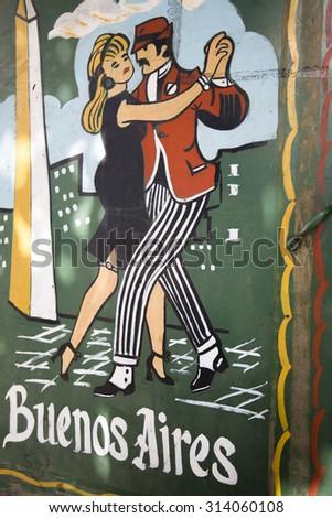 BUENOS AIRES, ARGENTINA, NOV 11: Colorful street art graffiti of tango in La Boca neighborhoods in Buenos Aires. Argentina 2014