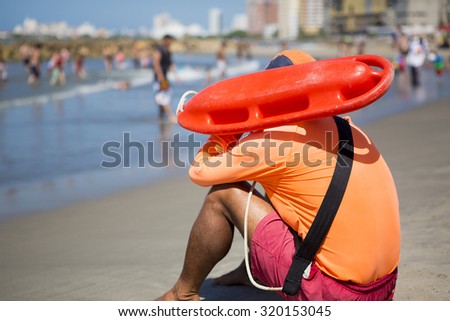 CARTAGENA, COLOMBIA, JANUARY 10: Young man life saver watching the situation on the sea in Bocagrande Beach in Cartagena, Colombia 2014.