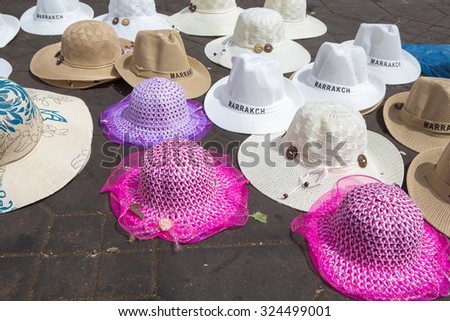 Various Moroccan hats laying on the floor of Jemaa el-Fnaa square, the market place in Marrakesh