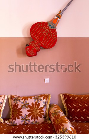 AIT-BEN-HADDOU, MOROCCO, AUGUST 31: Colorful classical Moroccan Interior withclassical music instrument on the wallt in the famous city of AÃ?Â¯t-ben-Haddou. Morocco 2014