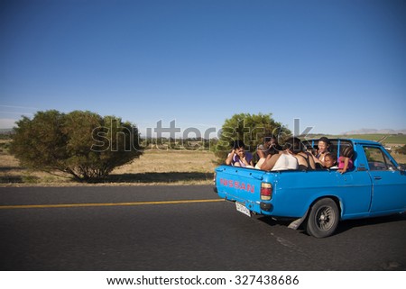 CAPETOWN, SOUTH AFRICA, DECEMBER 14: Unidentified group of african black people sitting at the back of a pick up car in Cape Town, close to the main Township, South Africa 2009.