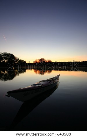 Early dawn morning breaks on smooth reflective water with kayak in foreground\
\
\
\
Time for Yourself to be with Yourself