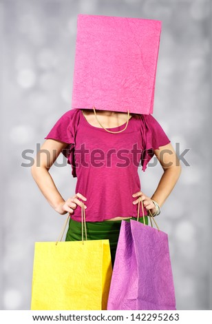 Girl with package on her head and two in the hands