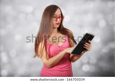 Student works with tablet pc at light background