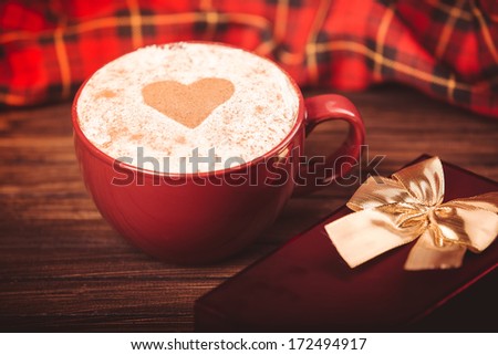 Cup of coffee,  little purple alarm clock and gift box