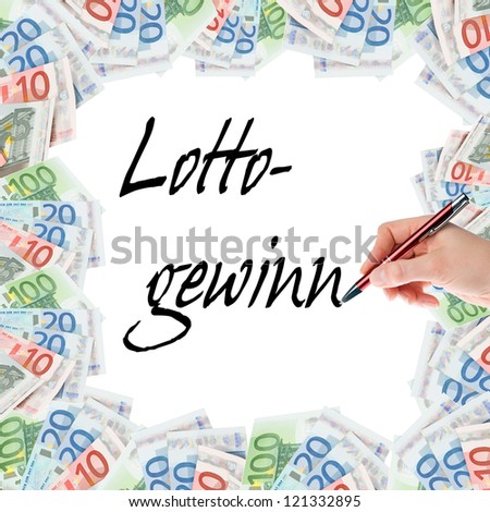 Hand with pen writing the word lottery win / lottery win