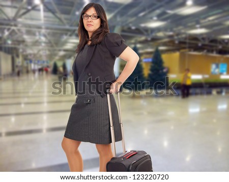 Business woman with suitcase at the airport / Business woman