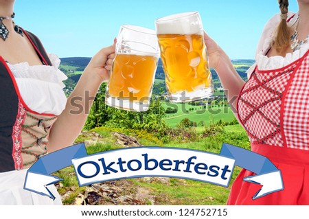 Two young pretty women in dirndl with beer mug / Oktoberfest