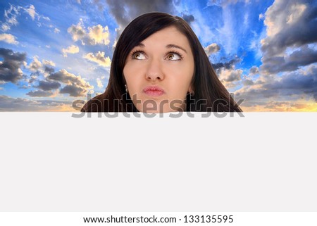 woman looking over a blank sign to heaven / woman looking