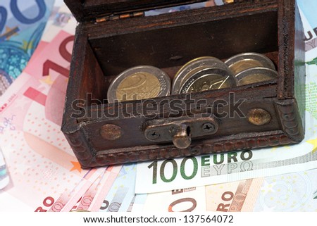 Treasure chest with coins and banknotes / euro money