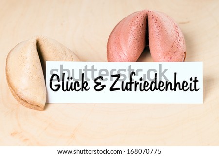 Fortune cookies with the german words Happiness and satisfaction / Fortune Cookie