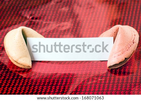 Fortune cookies with blank note over a red background / Fortune Cookies