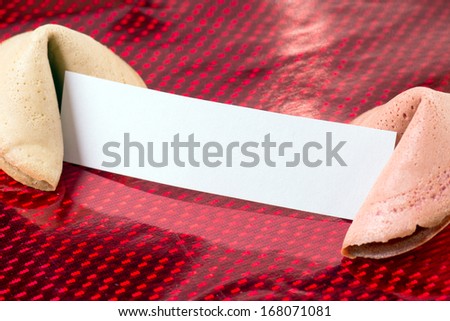 Fortune cookies with blank note over a red background / Fortune Cookie