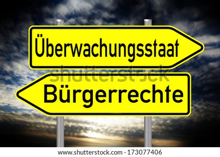 sign with the german words surveillance state and civil rights over a dark background / surveillance state