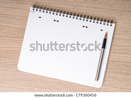 blank notepad with pen on a table / blank writing pad
