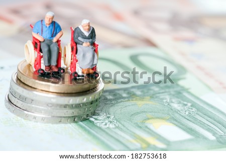 Old couple in a wheelchair with euro money / wheelchair users