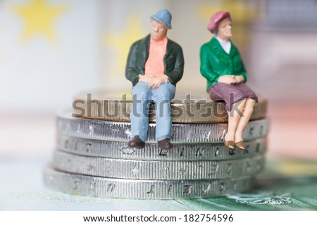 Grandma and Grandpa on a stack of euro coins / Grandma and Grandpa