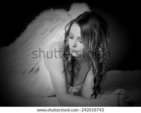 pretty woman in a angel costume in black and white / Angel