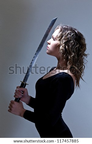 Pretty young woman with a samurai sword